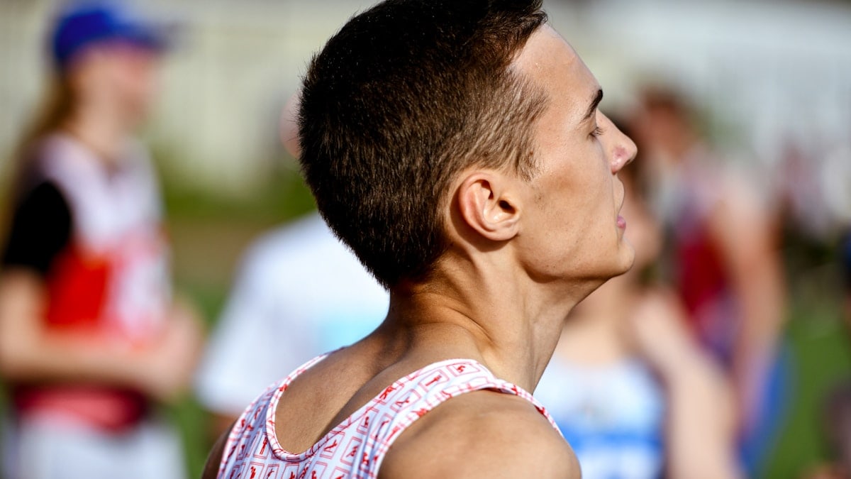 a man in a red and white tank top and a group of people